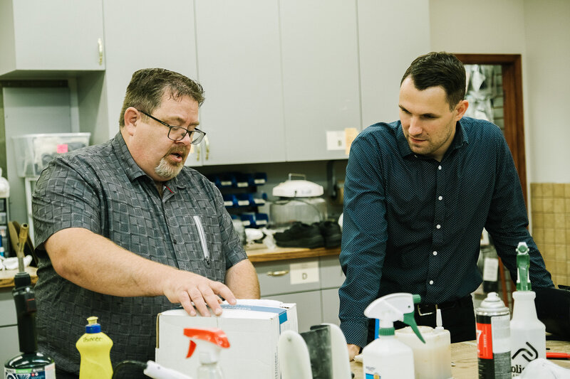 Two healthcare professionals discussing orthotics, a branch of healthcare that focuses on creating external solutions for mobility and alignment issues.