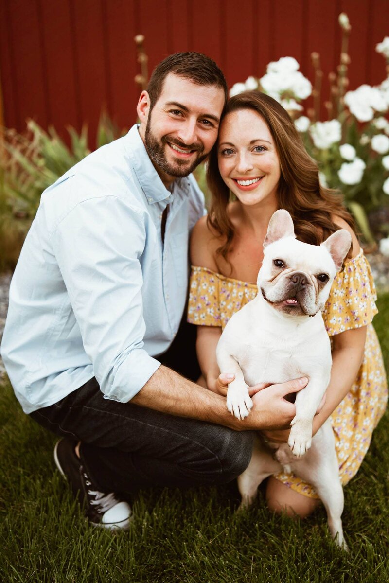 couple and dog pose for engagement photo