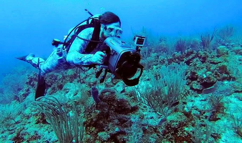 Jason Miller filming underwater cuts while traveling Belize.