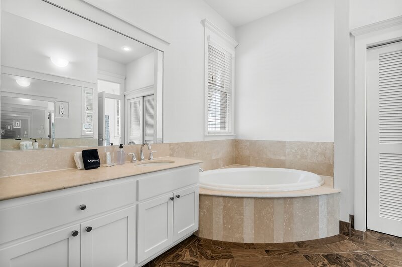 Luxury Primary Bathroom with Soaking Tub and Marble Details - Panama City Beach Vacation Home