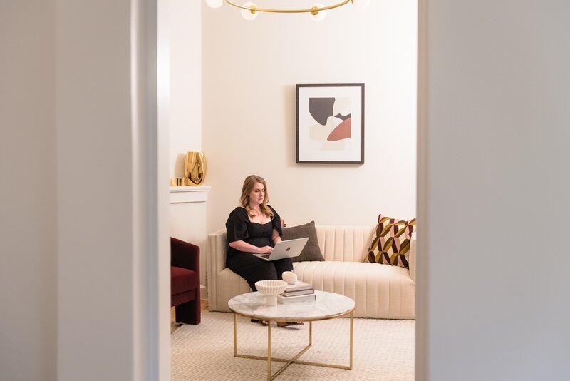 Kristen sitting in the living room of the Chatswood renovation where she added $1 million to the valuation
