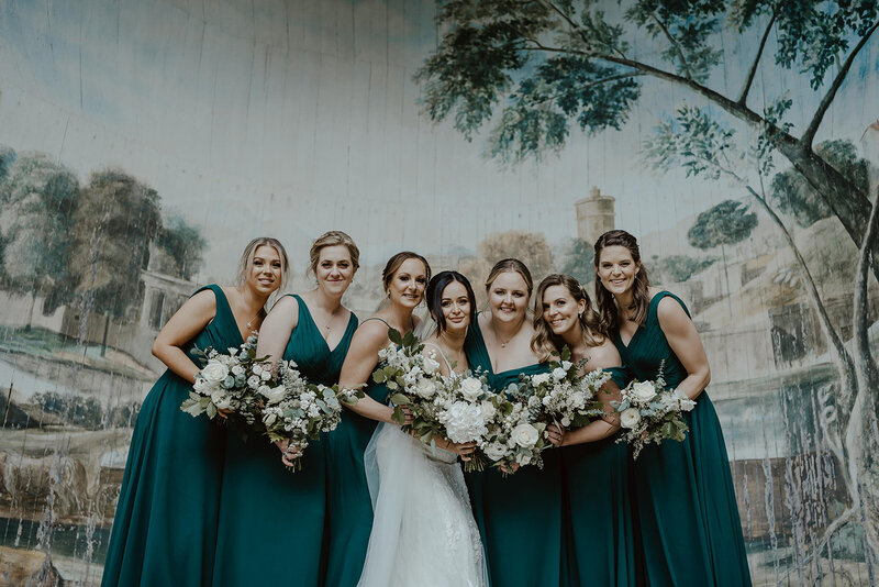 bride posing with bridesmaids