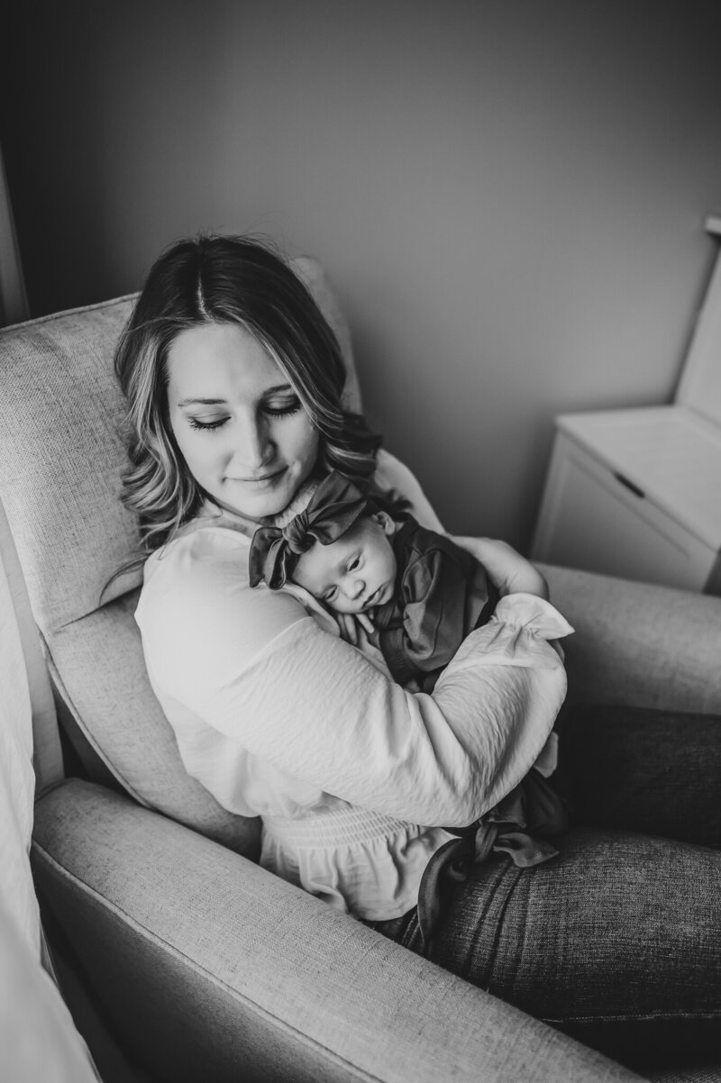 mother snuggling newborn baby