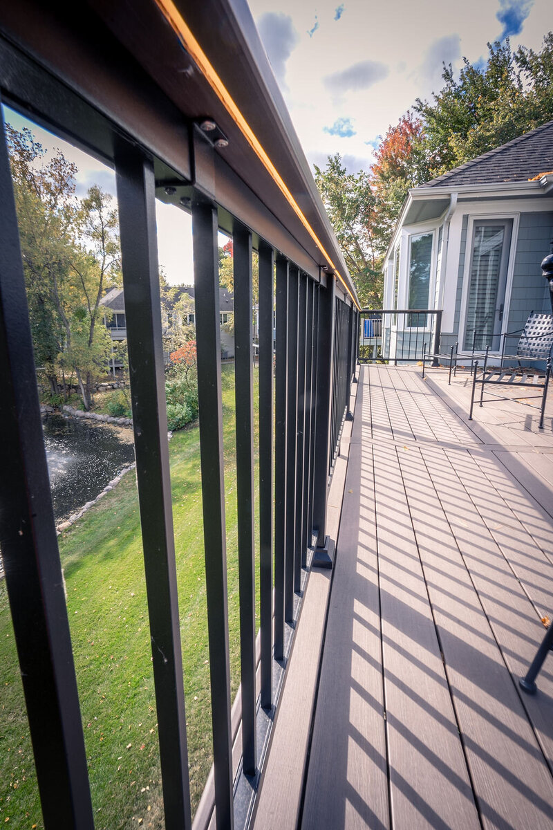 Underneath a TimberTech PVC drink rail with integrated LED strip light. 