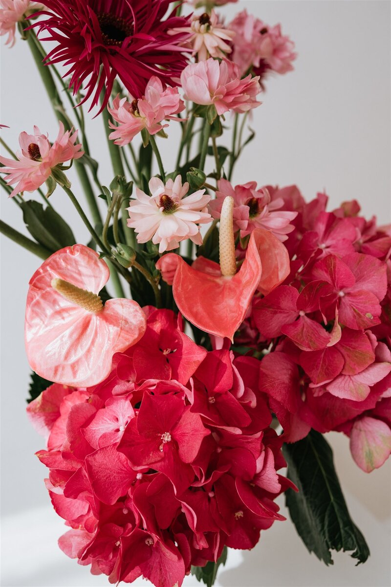 Close up of various pink flowers in an arrangement
