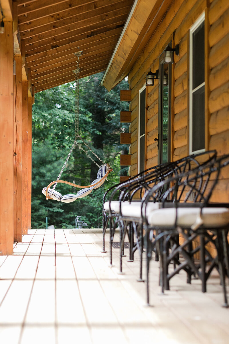 porch lined with chairs and swing