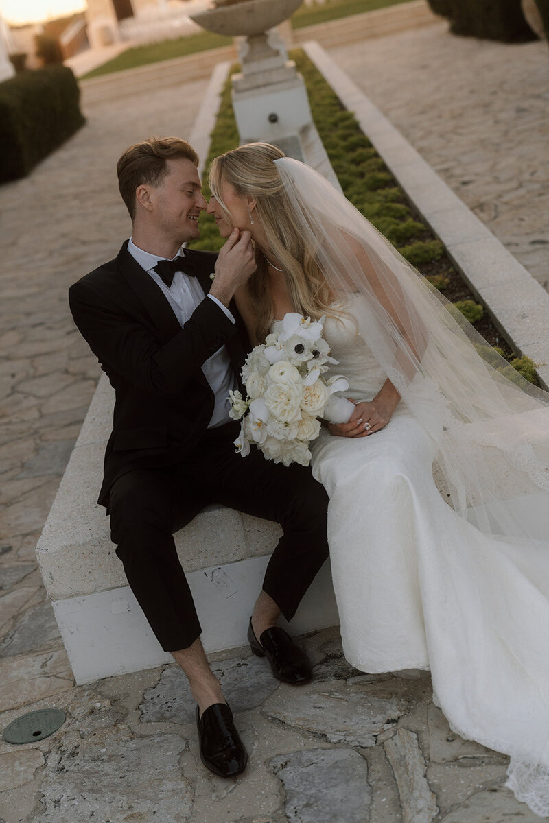 Bride and Groom go in for a kiss outside of Gulf Green