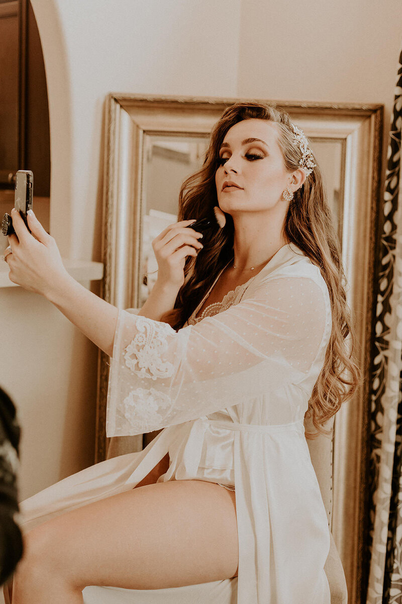 woman looking in mirror posing