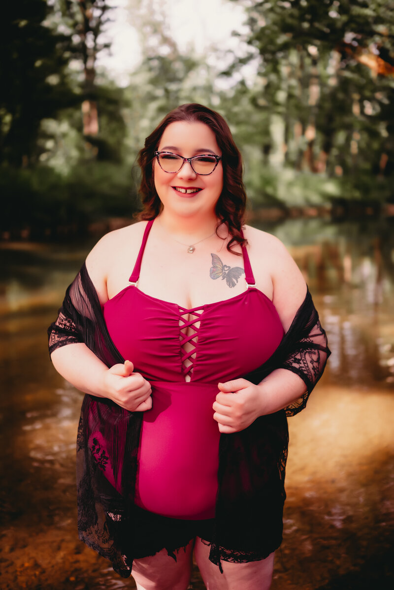 Woman in creek with red top