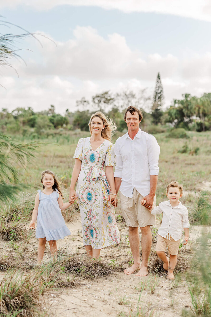 Girl and boy standing at a fancy doorway. Girl in yellow formal dress looking at boy while boy looks towards the camera. Captured by Rockhampton wedding photographer Julie-Anne Photography.