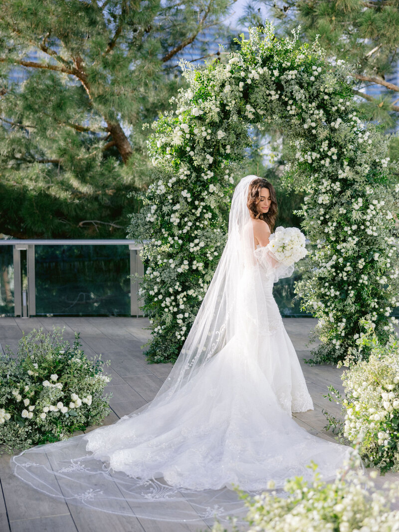 Chic bride and groom embrace on their wedding day on a rooftop overlooking Las Vegas