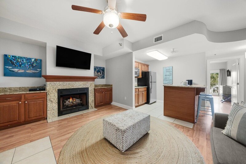 living room with fireplace and kitchenette