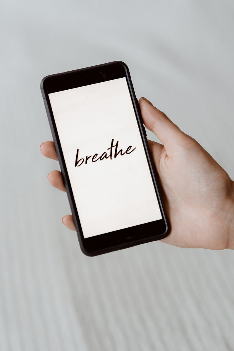 iPhone with the word breathe displayed, symbolising Financial Security