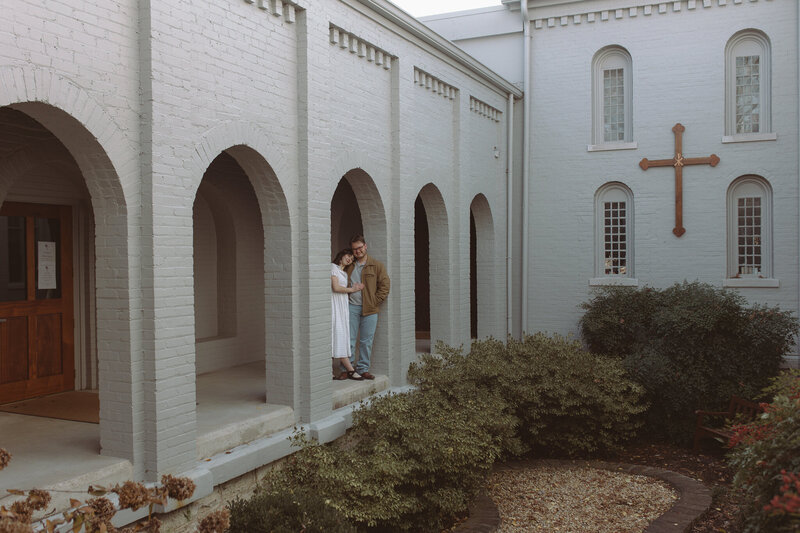 engagement session located in nashville tennessee where male is kissing his fiance on the head while she closes her eyes