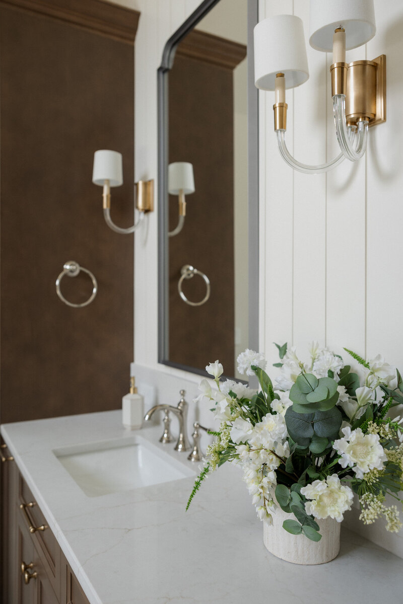 Refined entryway and staircase design in Roswell, Georgia with custom railing, neutral tones, and a warm, welcoming atmosphere by Megan Paterson Interiors.