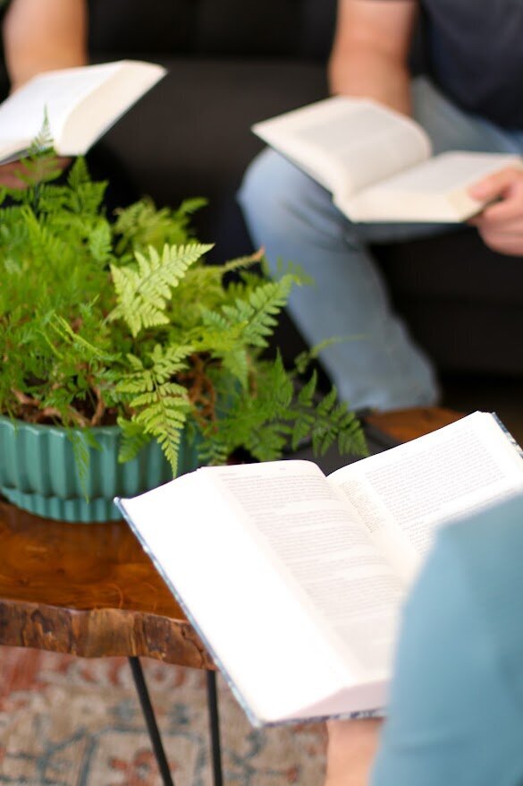 Men gather around a bible- Restoration