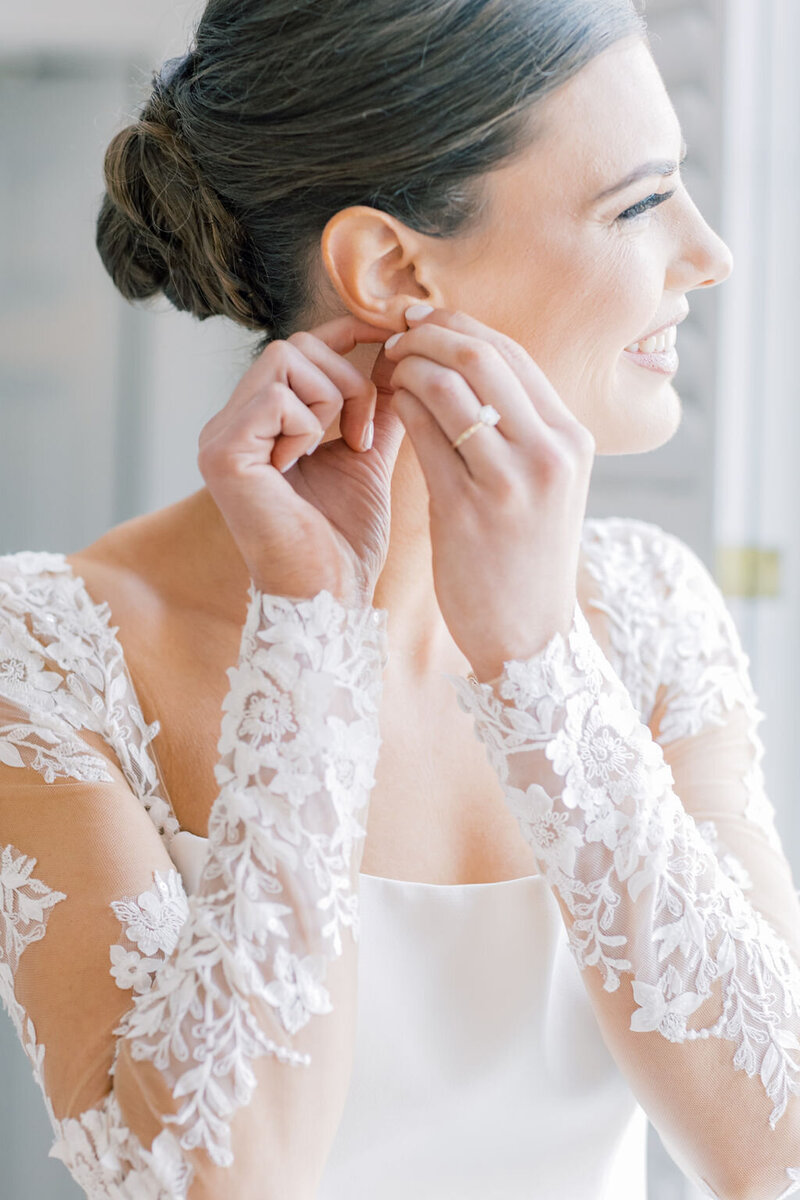 South Carolina Wedding Photographer | Beautiful bride putting on bridal earrings