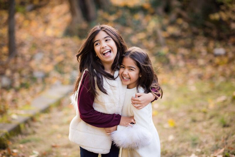 sisters hugging in sibling photo