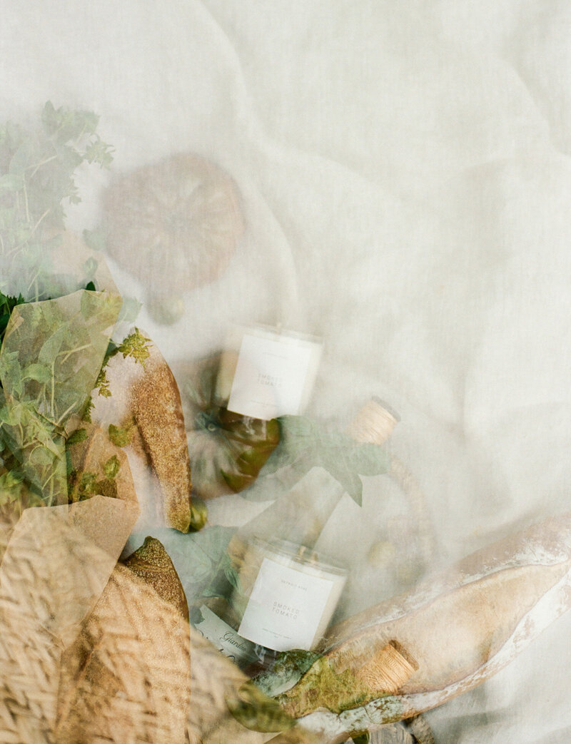 conceptual film candle branding photoshoot, scent photo, double exposure with candles, market tote, tomatoes, bread, herbs for Detroit Rose Smoked Tomato Candle