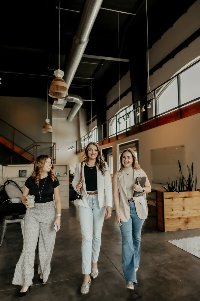 A photo of the Hummingbird Media team walking and smiling, holding their devices.