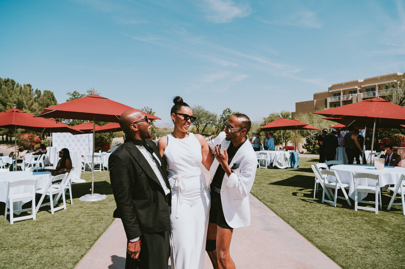 Three stylish guests laugh and pose at an upscale outdoor corporate event in Phoenix, Arizona—photographed by MISGIF to highlight authentic brand energy and guest engagement.