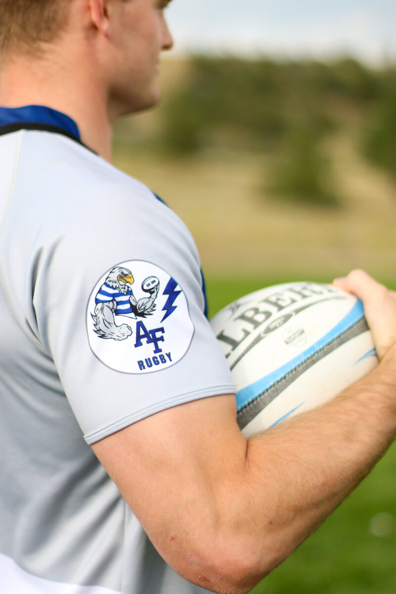 Close up of Men's Rugby player tying cleats - Zoomie Rugby
