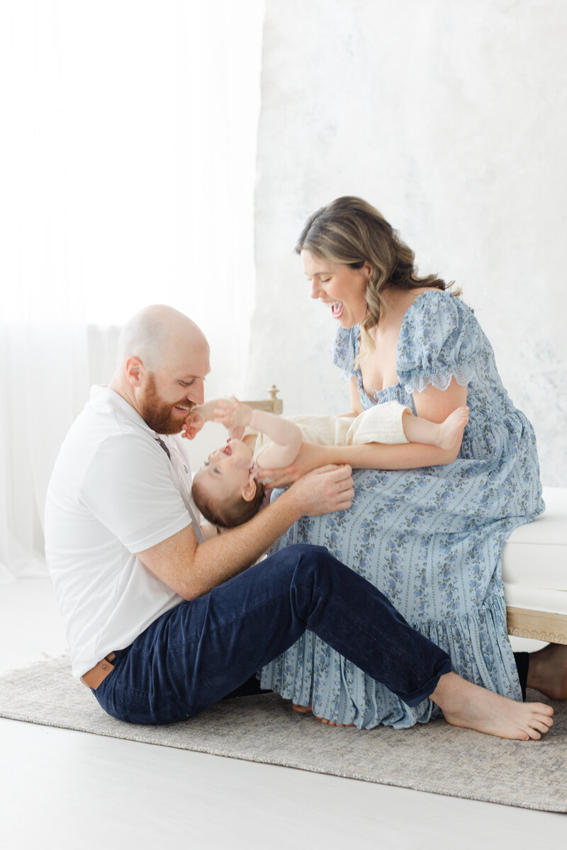 Parents laugh with 12 month old baby