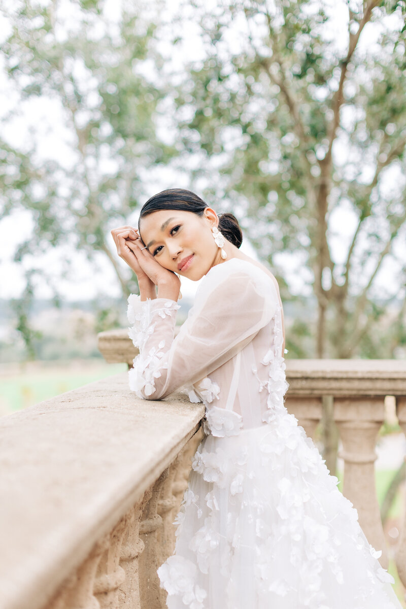 A bride on her wedding day at Bella Collina overlooking a balcony by Florida wedding photographer Angelika Krug Photo & Film.