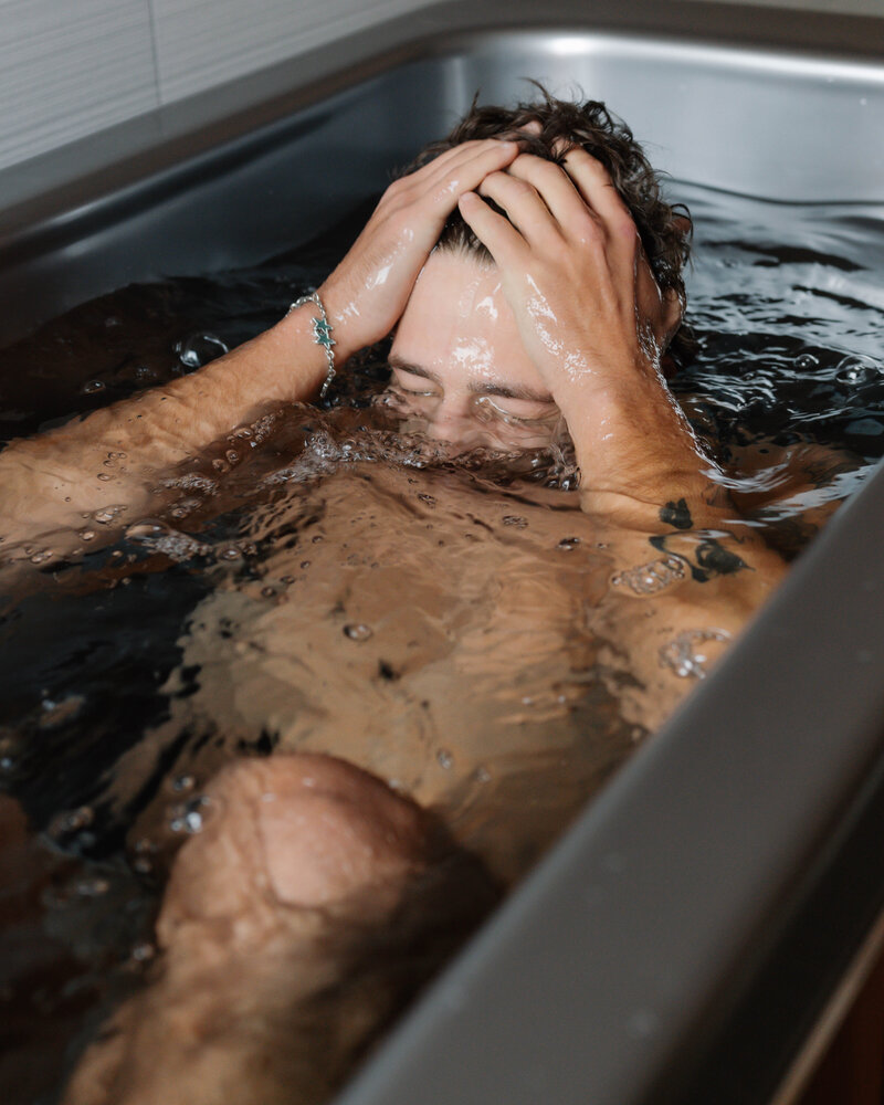 Man emerging from ice cold water at Vitalis demonstrating contrast therapy for circulation and mental clarity