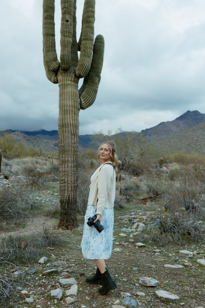 Brisa looking over her shoulder. She is in a desert nature preserve.