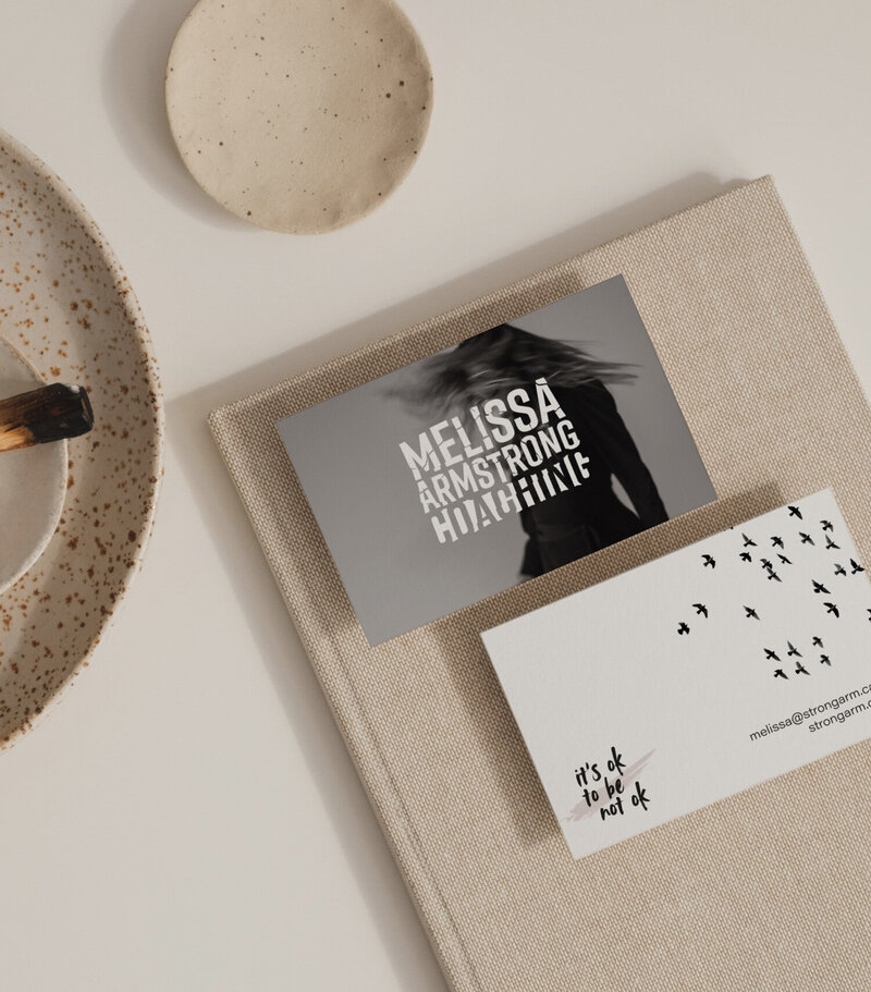 Flat lay of minimalist business card design for wellness coach Melissa Armstrong, featuring bold typography and the phrase "it's ok to be not ok"