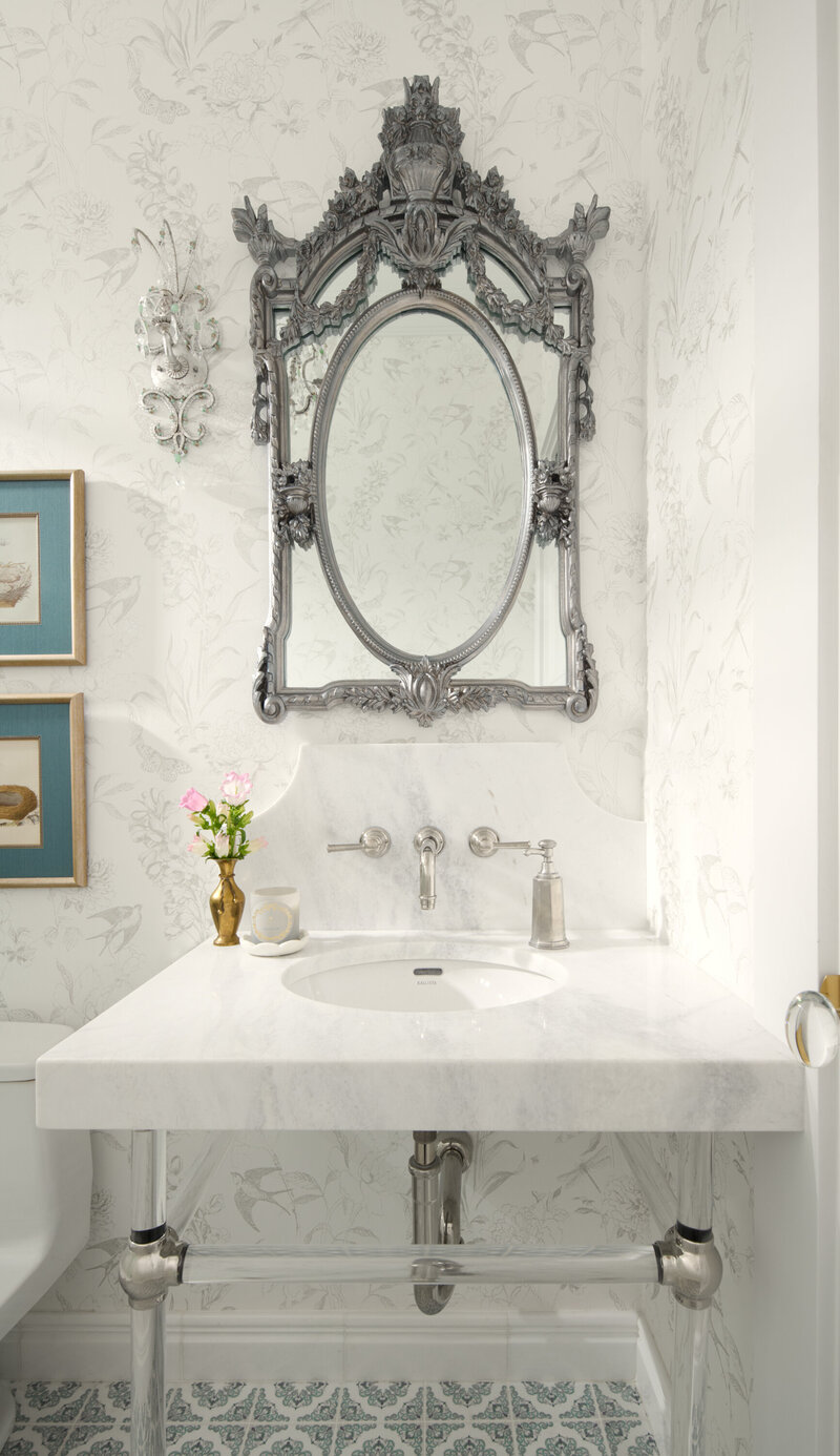 bathroom sink with silver mirror above sing