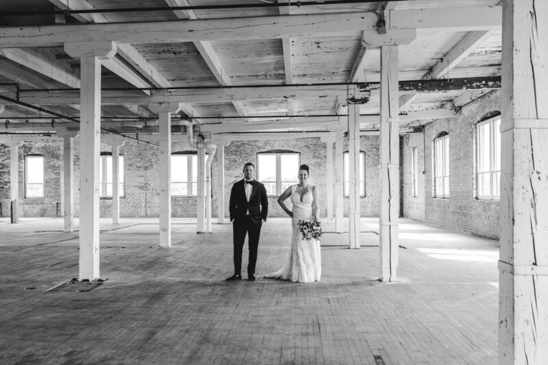 Bride and groom in vacant room at  Company 251 in Aurora, IL