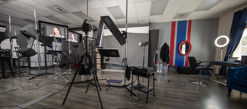 Photo studio with camera gear, lighting and backdrops.