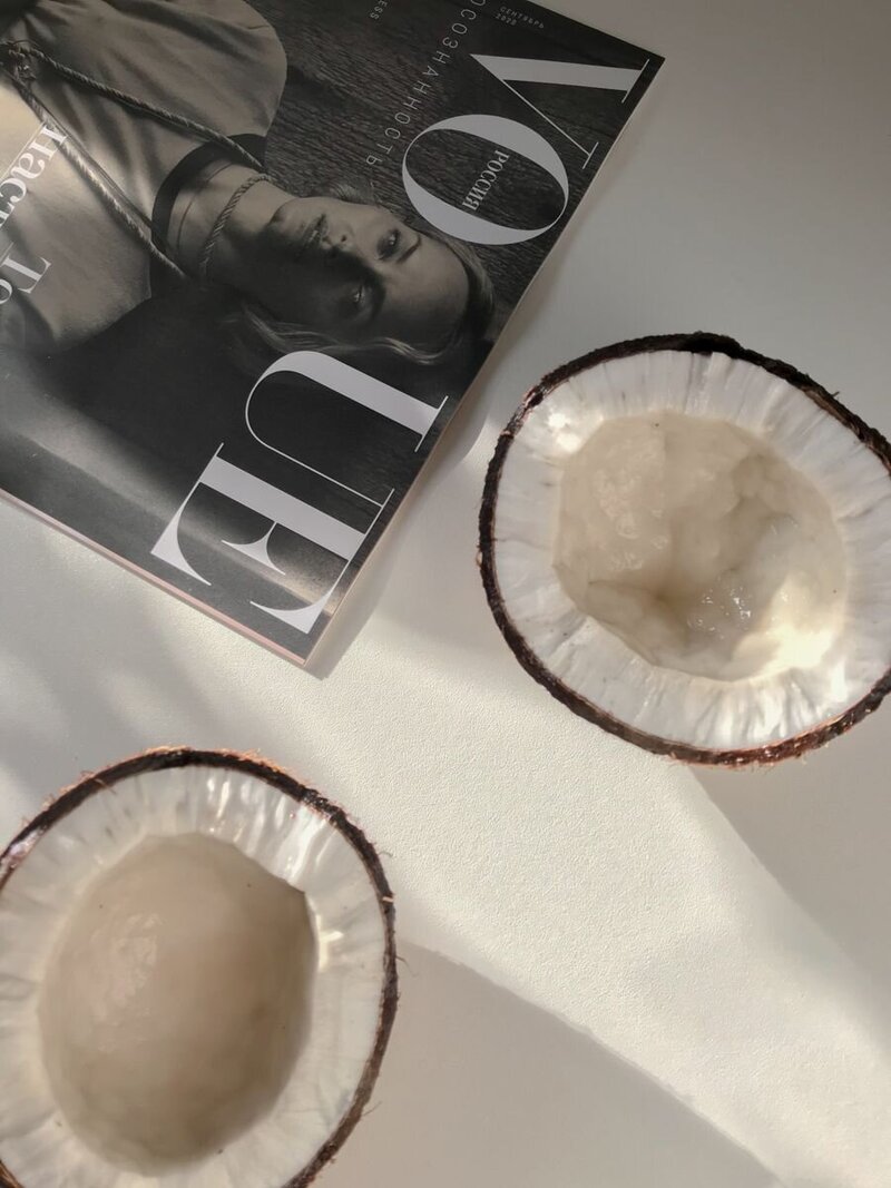 split open coconut and vogue magazine