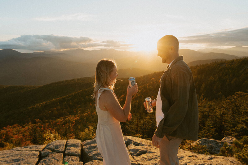 Couple drinking Summit beers together at sunset in the White Mountains of New Hampshire.