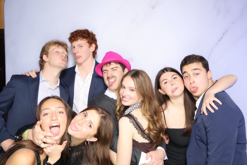 group of friends make faces in an open air photo booth at an event in chester county pa