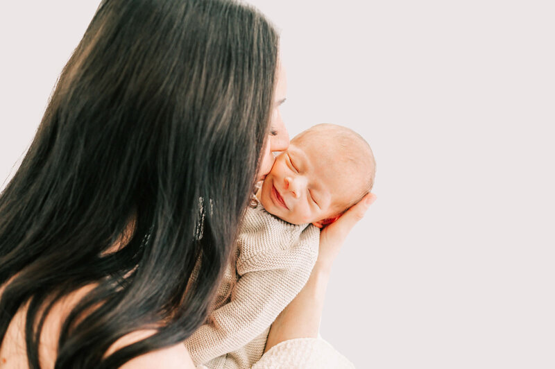 Springfield MO newborn photographer The XO Photography captures mom kissing smiling newborn boy