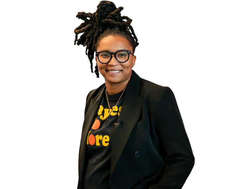 Alesia Hendley with hands in pockets smiling to the camera