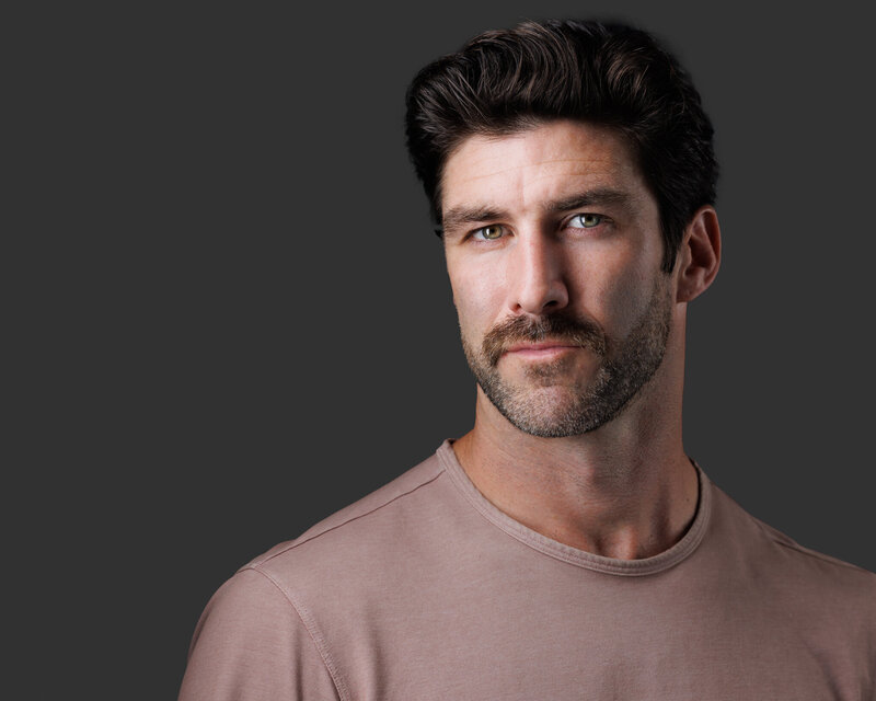 Male with beard grinning