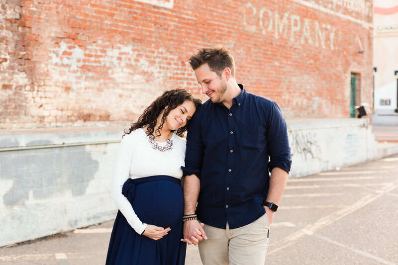 mom and dad together in downtown Phoenix maternity session