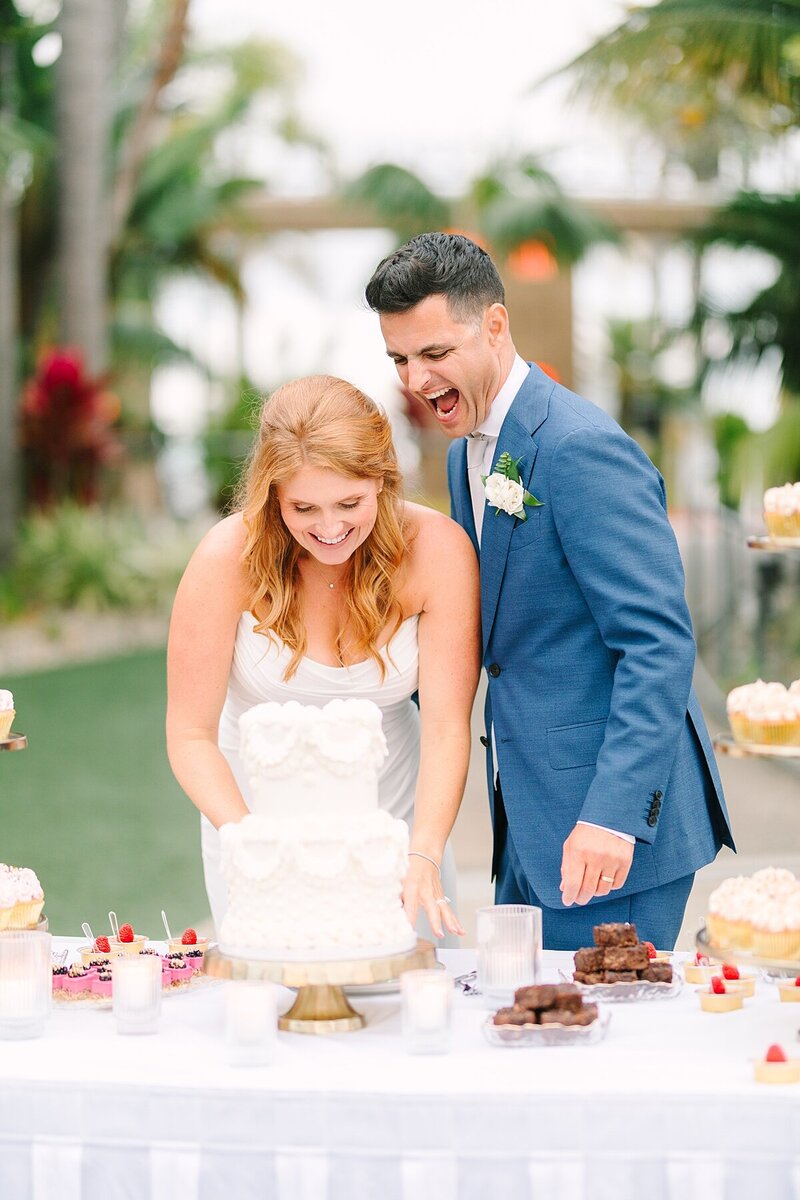 Bride and groom cutting their wedding cake at Humphrey's Half Moon Inn on Shelter Island in San Diego.