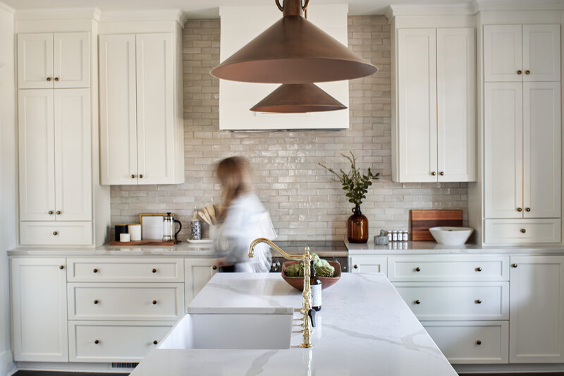 "Discover the ultimate in timeless kitchen design with this stunning space by Elle Luna Interiors. Neutral cabinets create a clean and classic look, while a striking focal range wall adds a touch of drama and sophistication. The large island offers ample space for cooking, entertaining, and gathering with family and friends. Whether you're a seasoned chef or a home cook, this kitchen is sure to inspire your culinary creativity. Get ready to fall in love with this stylish and functional kitchen that will stand the test of time!"