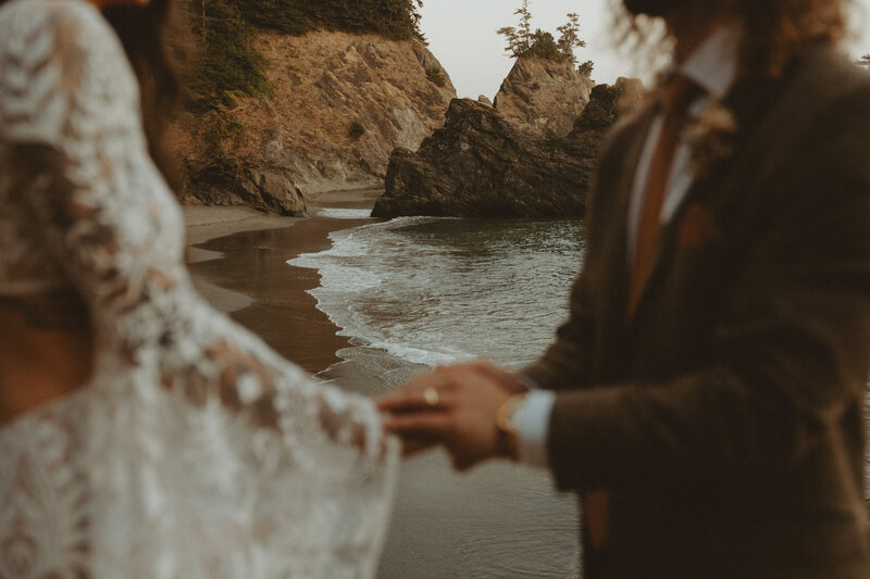 Elopement couple walking along grassy path in Oregon