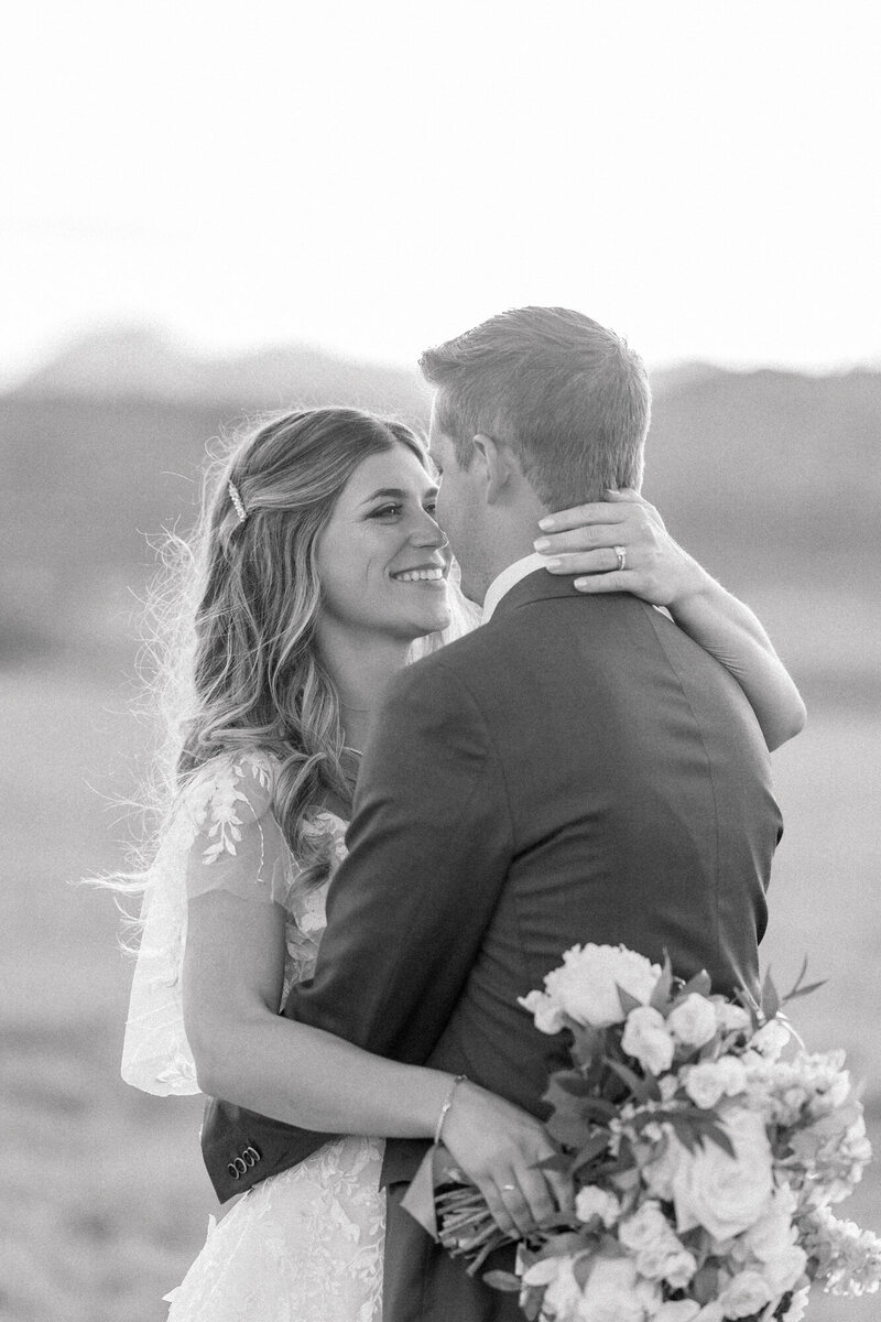 black and white image of a couple nose to nose
