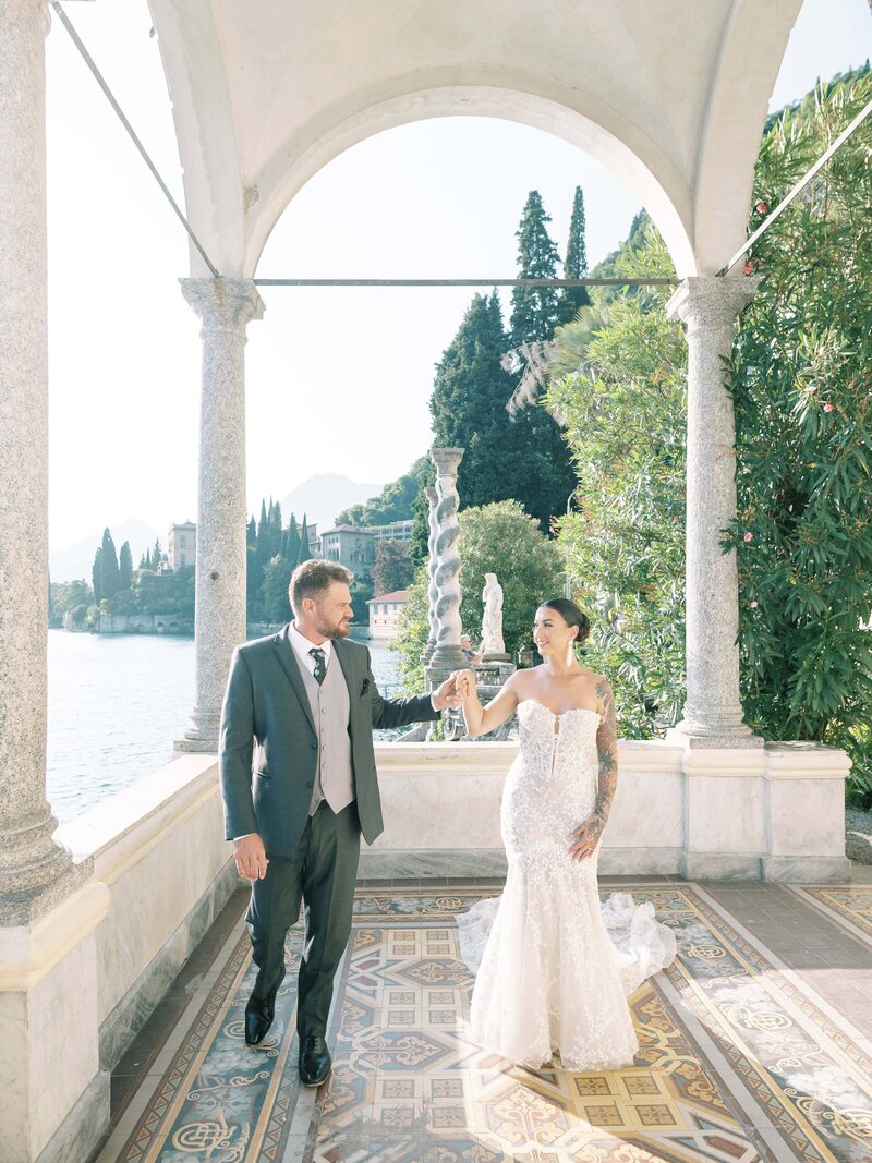 bride-and-groom-in-front-of-flower-arch