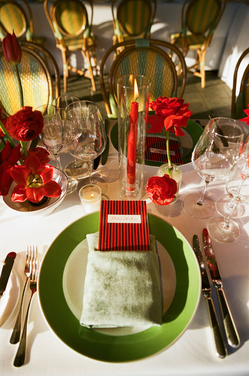 Green-rimmed plate with a red striped place card