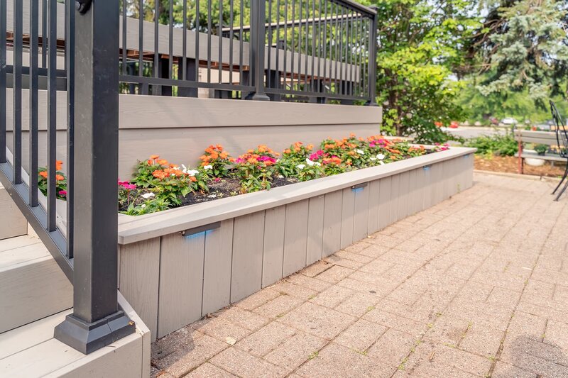 Composite flower bed with integrated LED lights which can be faintly seen during the daytime. 