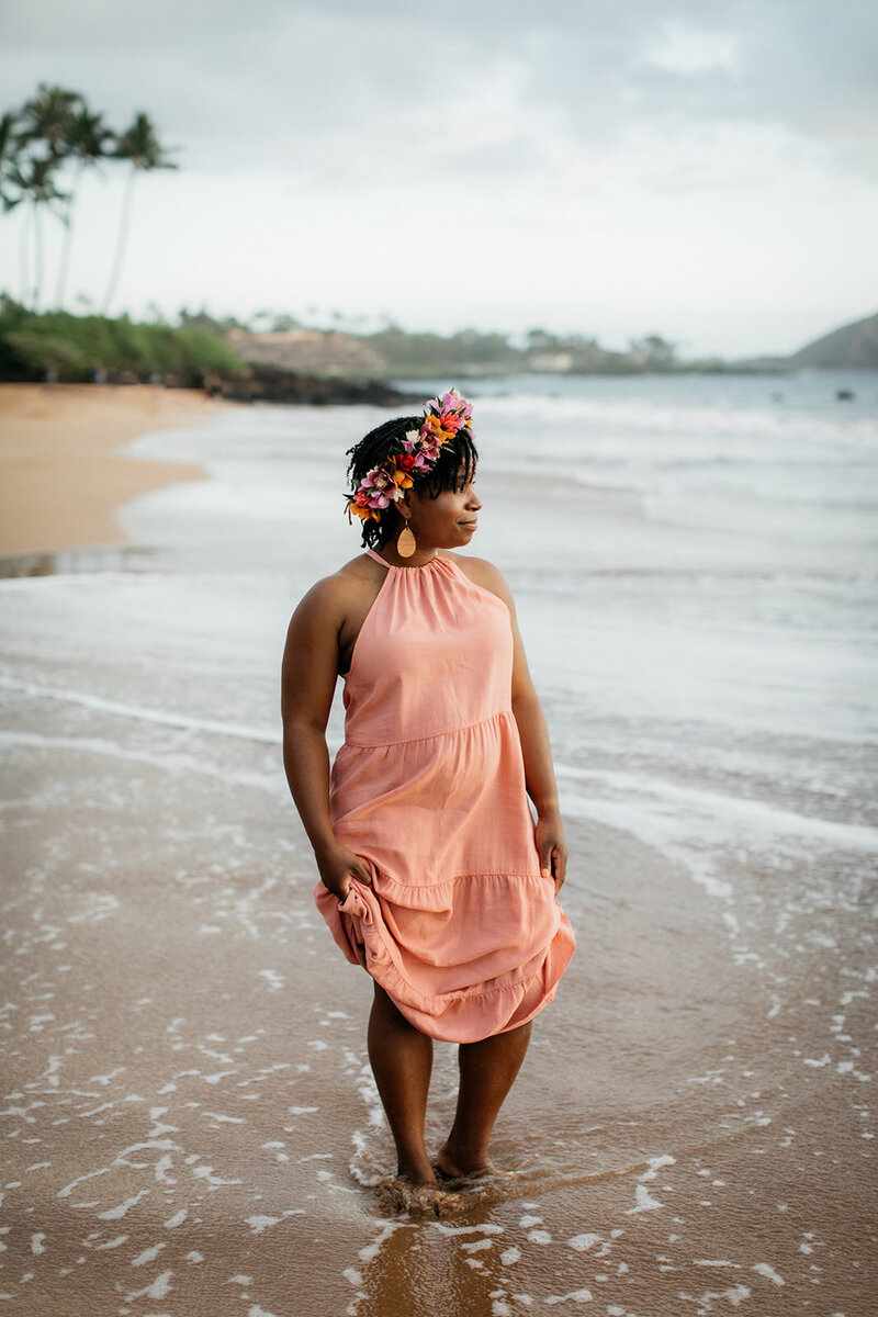 Yvette Henry standing in the sand by the ocean.