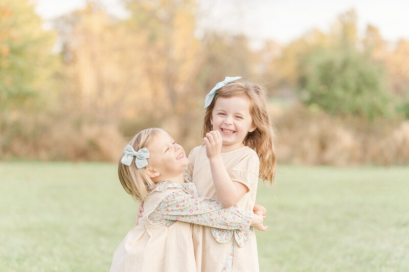 siblings hugging each other laughing during NoVa fall mini session